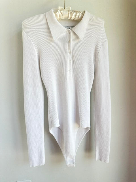 Picture of a the Endless Rose Button Down Body Suit Ivory hanging on a clothes hanger over a white background - CT Grace