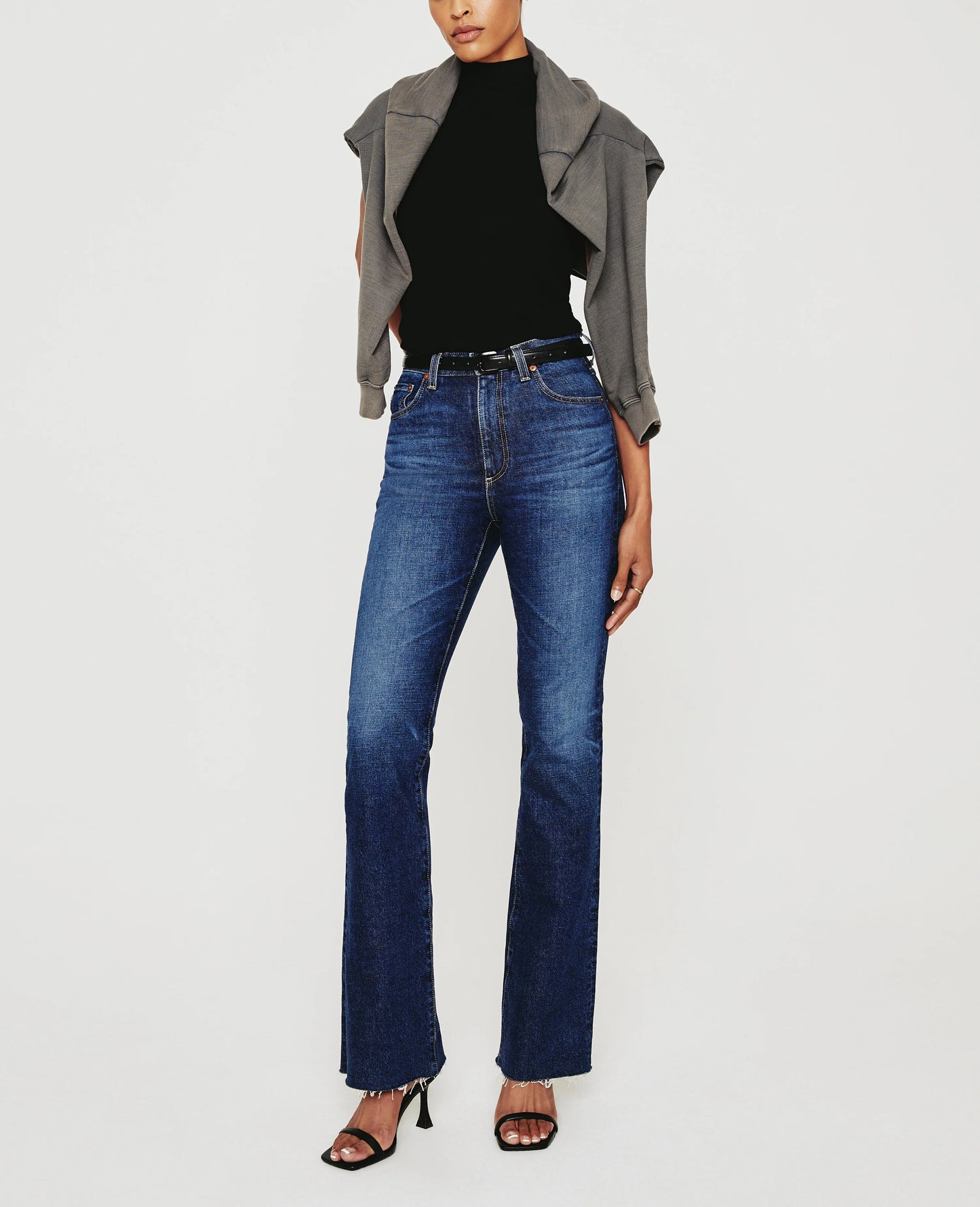 Picture of a model wearing the AG Jeans Medium Wash Alexxis Boot - CT Grace