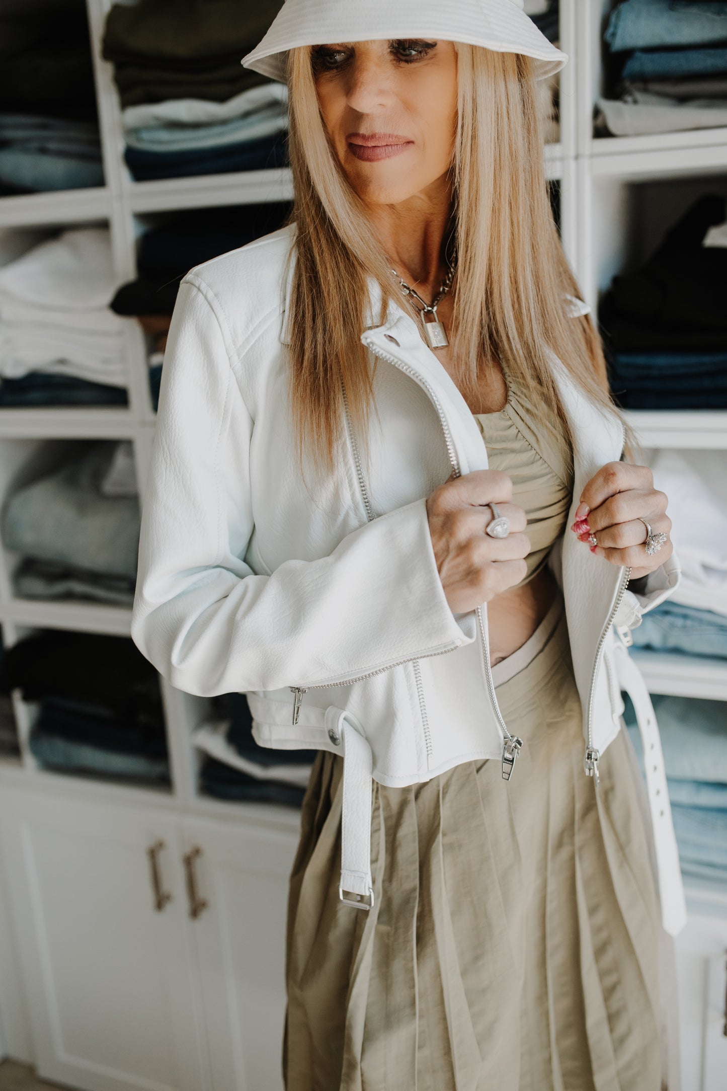 Picture of a blonde looking down model using the Moon River Sleeveless Spaghetti Strap Crop Top- CT Grace