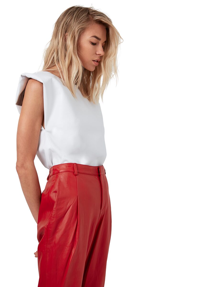 Picture of a blonde model looking down using the ASbyDF Blaze White Leather Tee - CT Grace