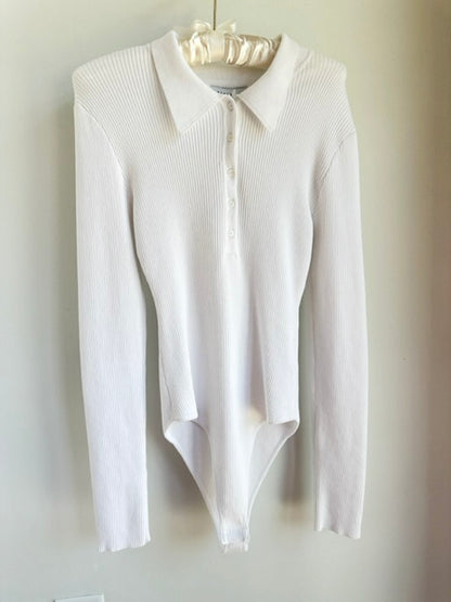 Picture of a the Endless Rose Button Down Body Suit Ivory hanging on a clothes hanger over a white background - CT Grace