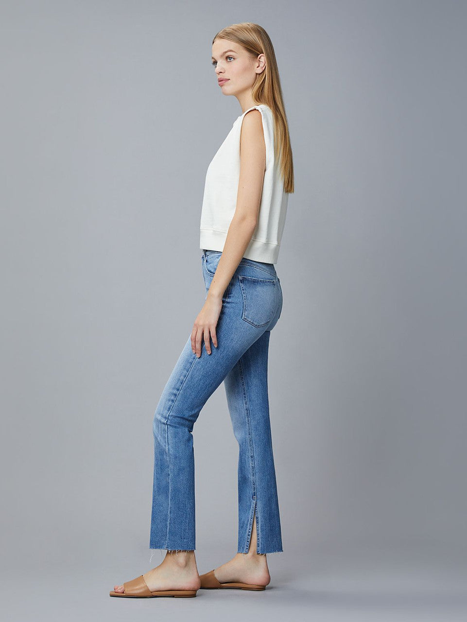 Side picture of a model wearing the DL1969 Patti Straight Vintage Reef Raw - CT Grace