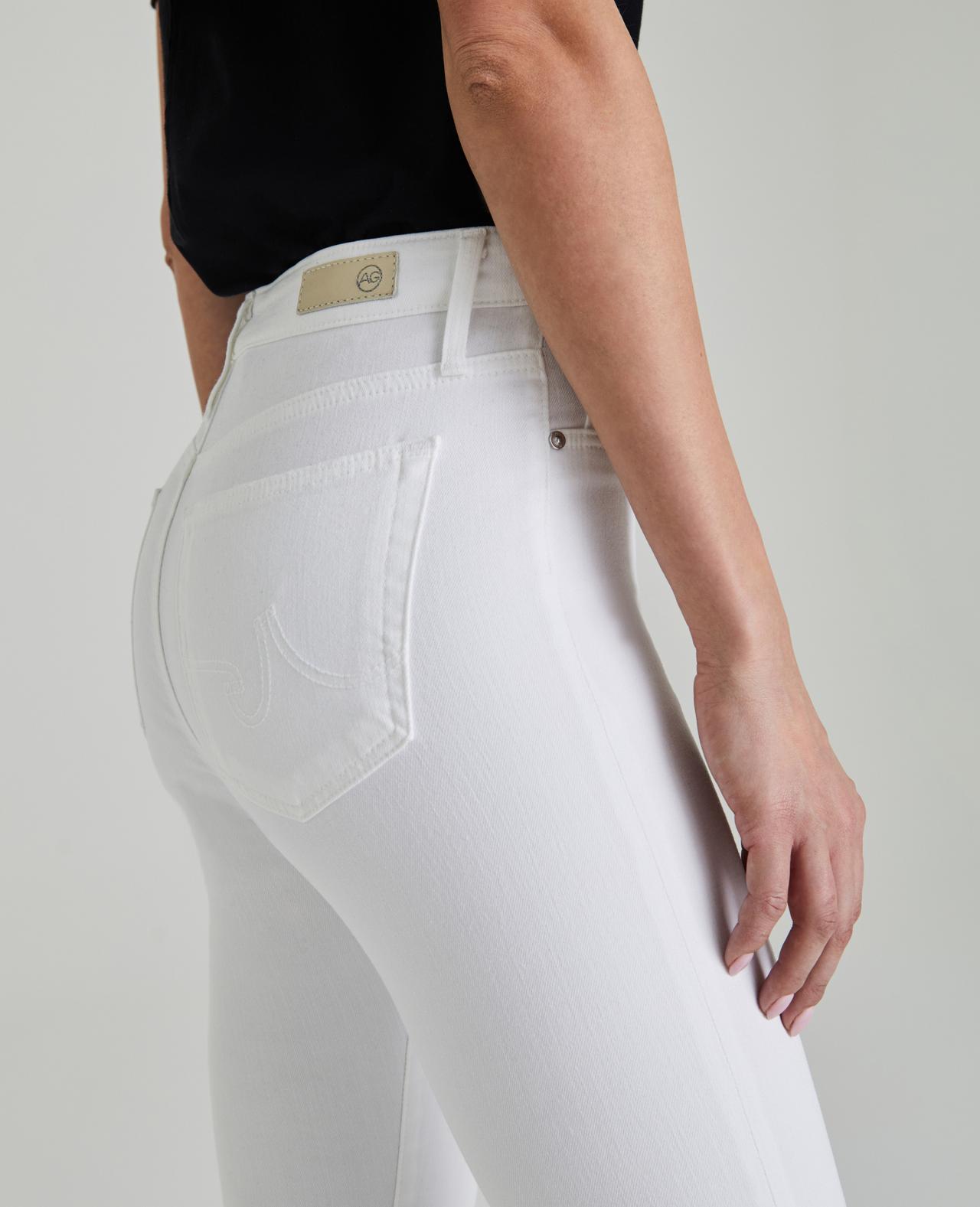 Side picture of a model wearing the AG White the Farrah Skinny ankle - CT Grace