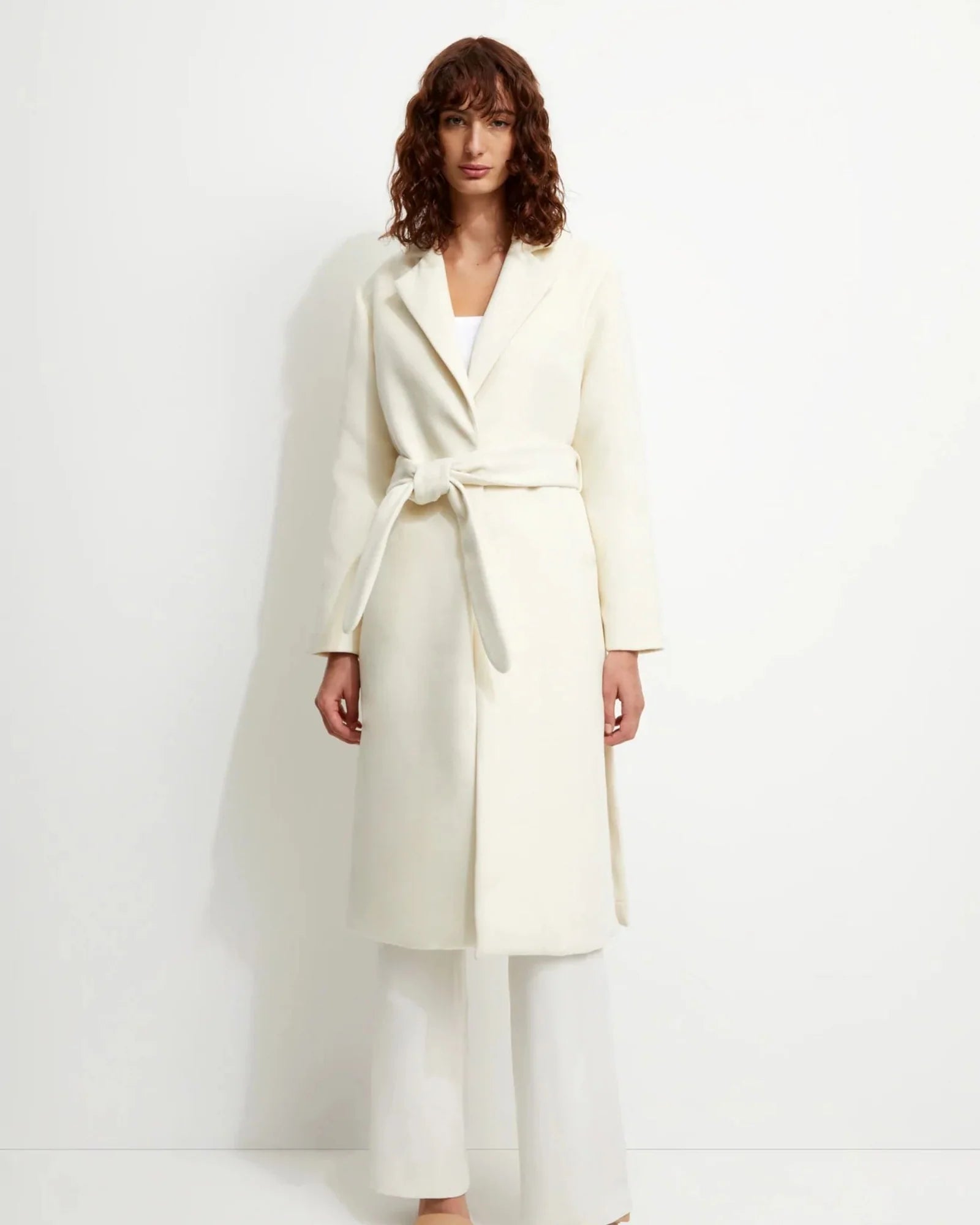 Front picture of a model wearing the Unreal Fur Off White Long Coat - CT Grace