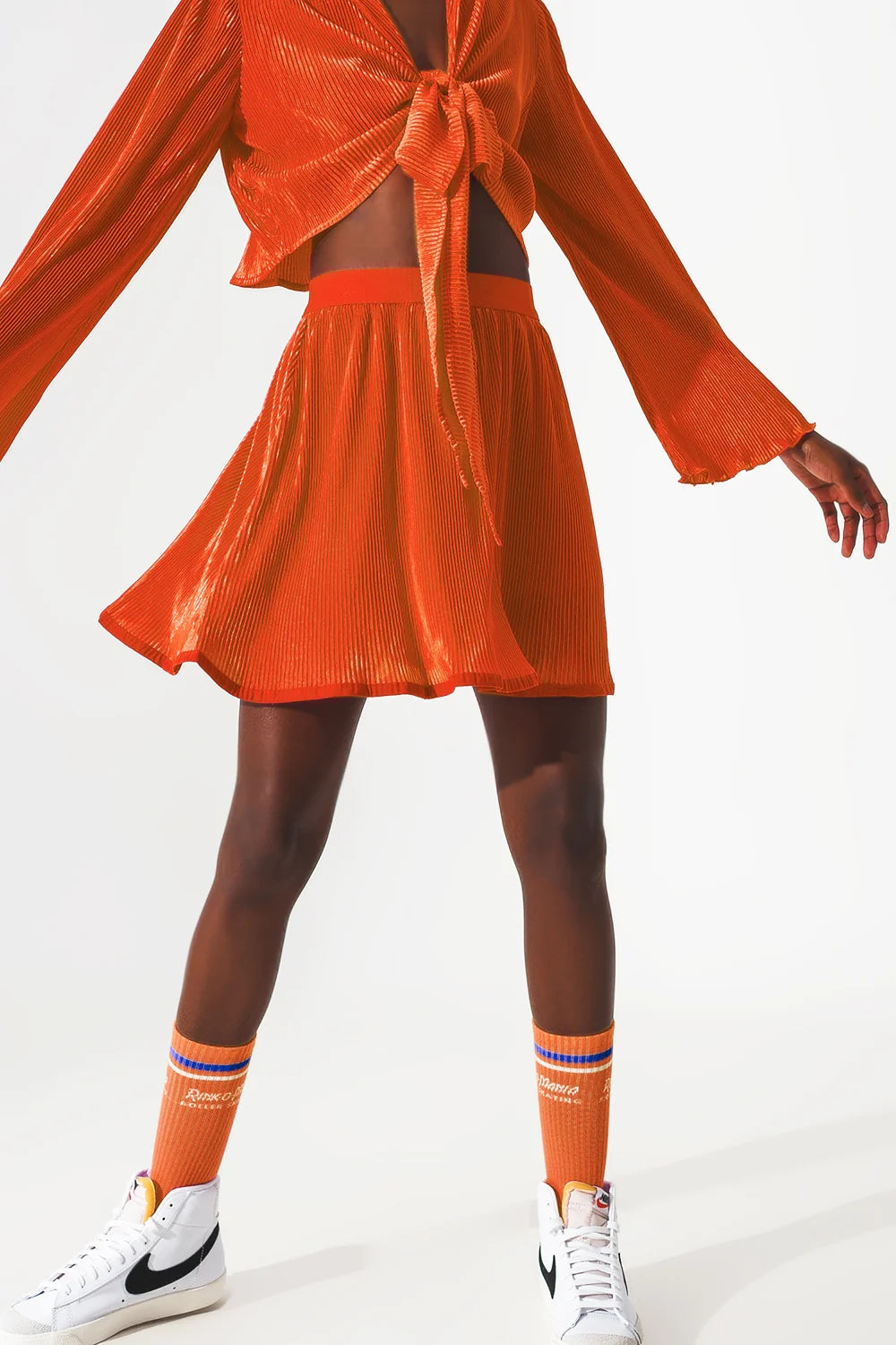 Front zoom picture of the Q2 Pleated Short Skirt in Orange - CT Grace