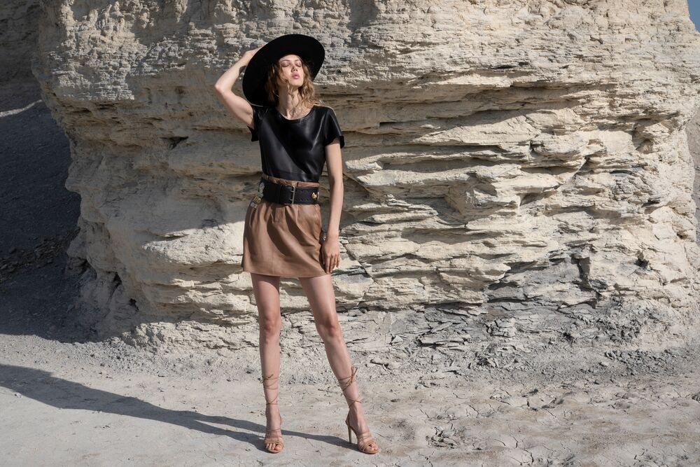 Picture of a model standing on a rocky background using the ASbyDF New Guard Recycled Leather Tee - Black - CT Grace